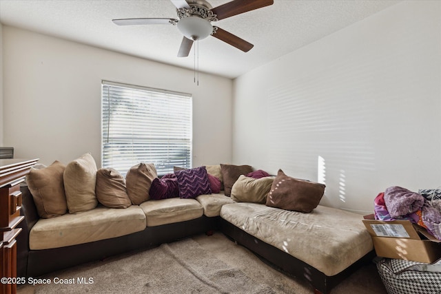 living room with ceiling fan and carpet