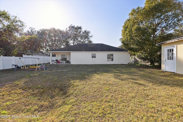 rear view of property with a yard