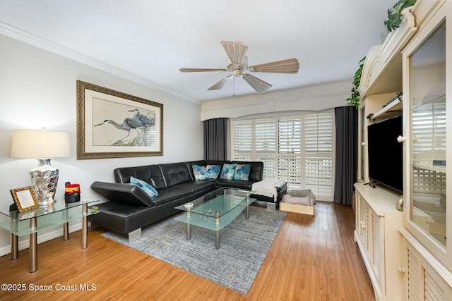 living room featuring ceiling fan, crown molding, a textured ceiling, and hardwood / wood-style flooring