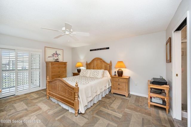 bedroom with access to outside, a textured ceiling, and ceiling fan