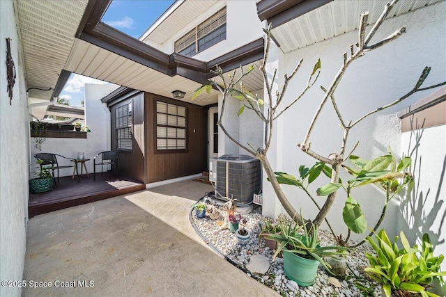 view of patio featuring central AC unit and a porch