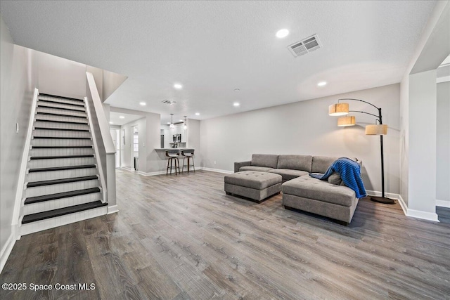 living room with hardwood / wood-style floors and a textured ceiling