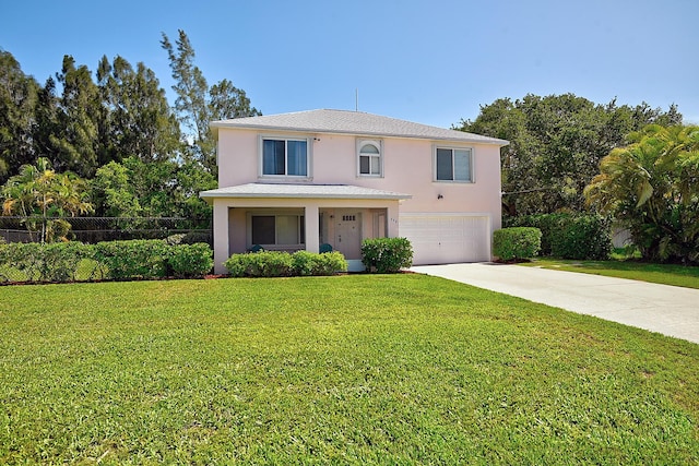 view of front of property with a front yard and a garage