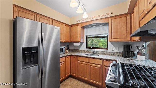 kitchen featuring sink, backsplash, stainless steel refrigerator with ice dispenser, and range with gas stovetop