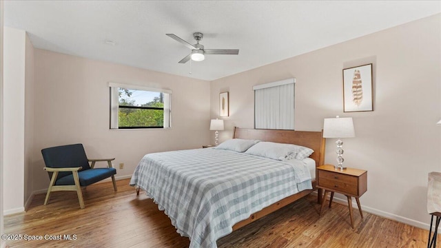 bedroom with ceiling fan and dark hardwood / wood-style flooring