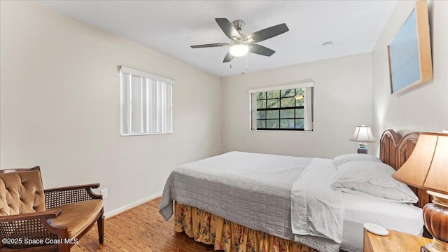 bedroom with ceiling fan and hardwood / wood-style floors