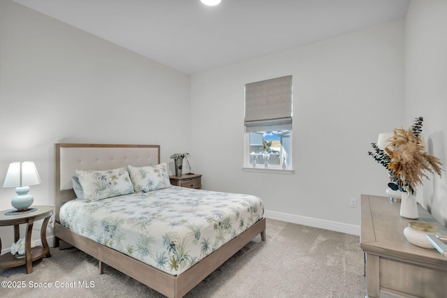 bedroom featuring light colored carpet