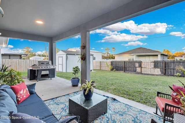 view of patio / terrace featuring an outdoor living space, a shed, and grilling area