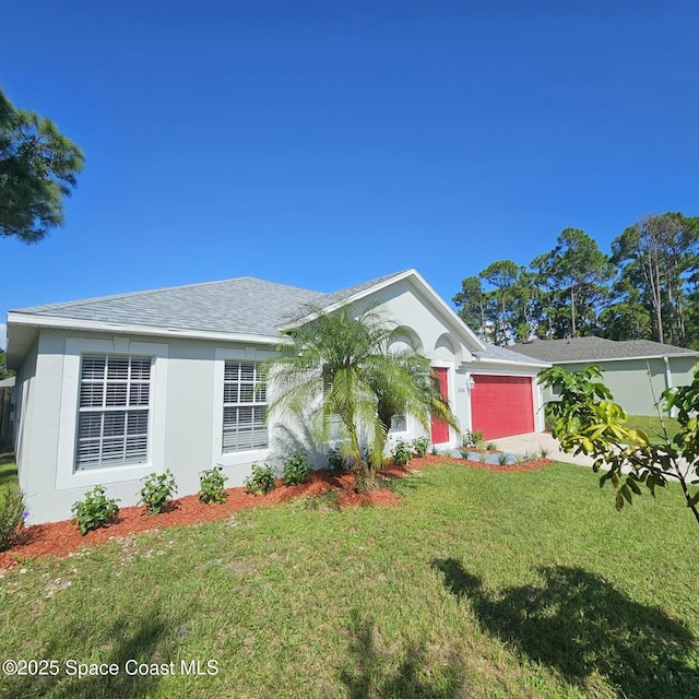 ranch-style home with a garage and a front yard