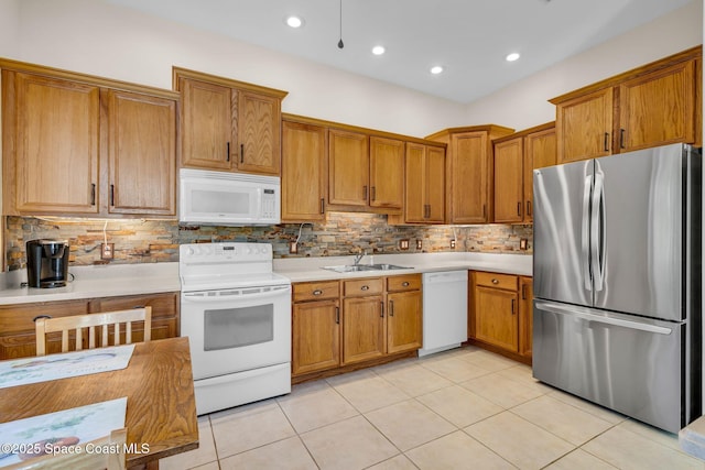 kitchen featuring light tile patterned flooring, white appliances, backsplash, and sink