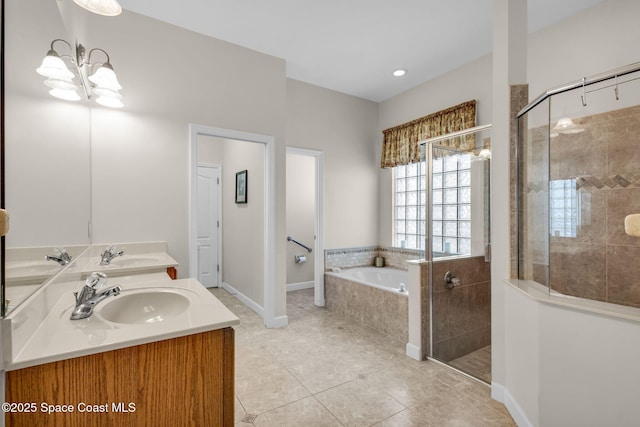 bathroom with tile patterned floors, vanity, separate shower and tub, and an inviting chandelier