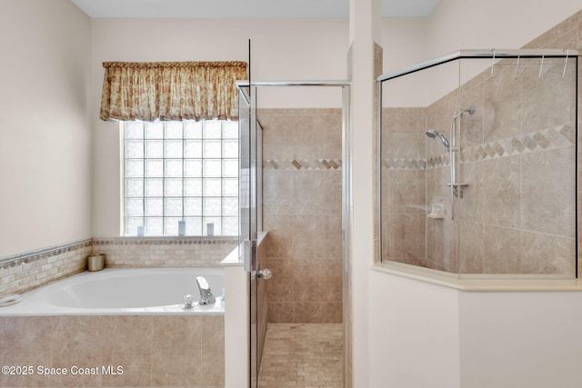 bathroom featuring shower with separate bathtub