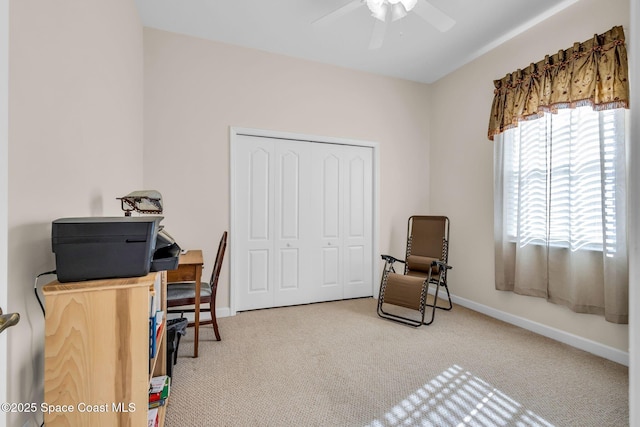 carpeted office space with ceiling fan