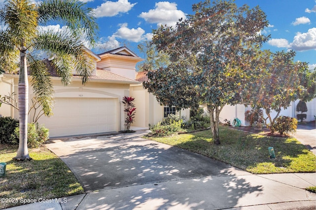 view of property hidden behind natural elements featuring a garage and a front yard