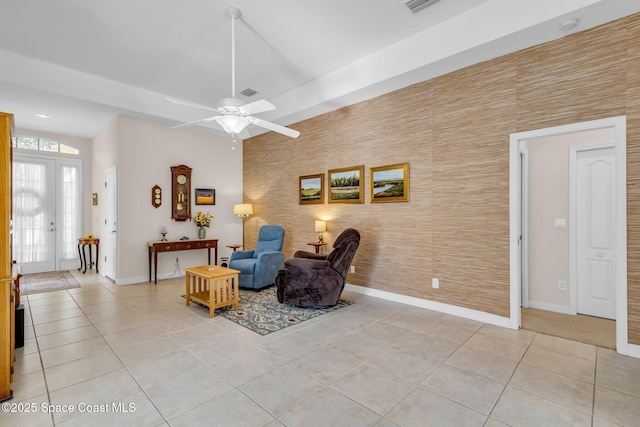 living area with ceiling fan, french doors, and light tile patterned floors