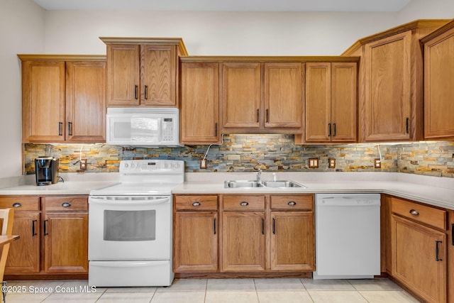 kitchen with tasteful backsplash, sink, light tile patterned flooring, and white appliances