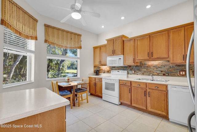 kitchen with ceiling fan, sink, tasteful backsplash, white appliances, and light tile patterned flooring