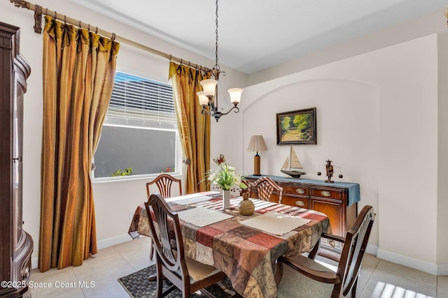 tiled dining area with a notable chandelier