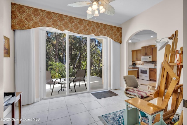 living room with ceiling fan and light tile patterned flooring