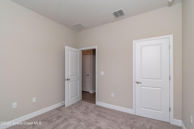 unfurnished bedroom featuring light colored carpet