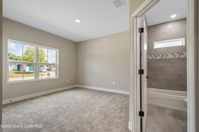 228 Dunlap Ave SE, Palm Bay, FL 32909 - spare room featuring baseboards, plenty of natural light, carpet flooring, and visible vents