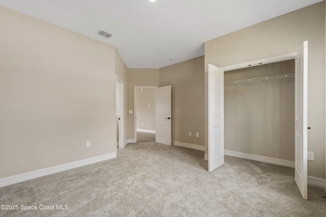 228 Dunlap Ave SE, Palm Bay, FL 32909 - unfurnished bedroom featuring a closet, baseboards, carpet flooring, and visible vents
