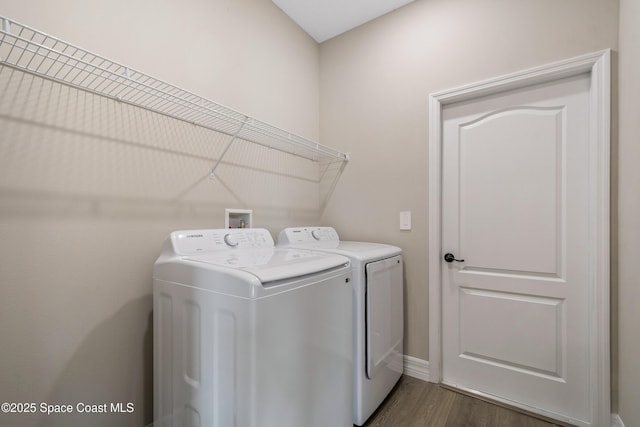 228 Dunlap Ave SE, Palm Bay, FL 32909 - washroom with laundry area, dark wood-style floors, washing machine and dryer, and baseboards