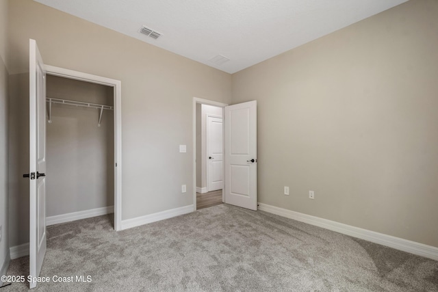 228 Dunlap Ave SE, Palm Bay, FL 32909 - unfurnished bedroom featuring carpet floors, baseboards, visible vents, and a closet