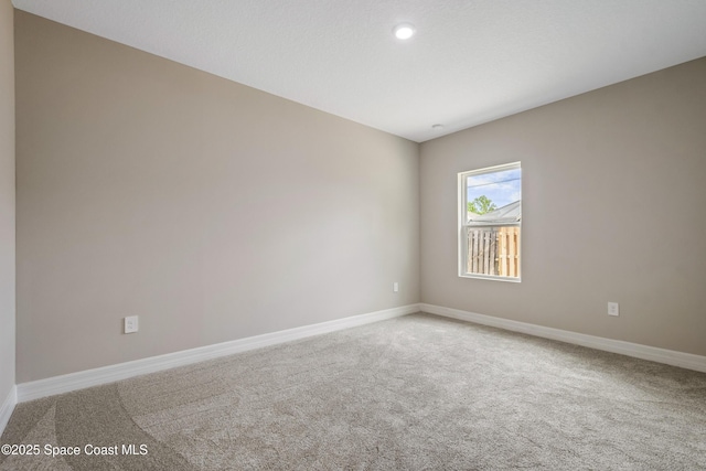 228 Dunlap Ave SE, Palm Bay, FL 32909 - spare room featuring recessed lighting, baseboards, and carpet