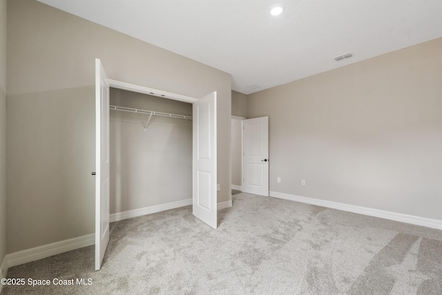 228 Dunlap Ave SE, Palm Bay, FL 32909 - unfurnished bedroom with visible vents, carpet flooring, baseboards, and a closet