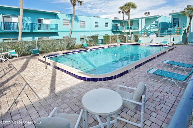 view of swimming pool with a patio area