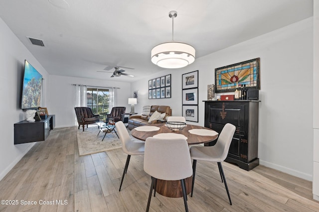 dining area featuring ceiling fan and light wood-type flooring