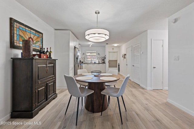 dining space with light wood-type flooring