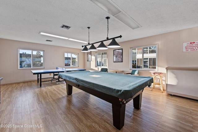 recreation room with a textured ceiling, light hardwood / wood-style flooring, and pool table