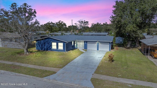 ranch-style home featuring a yard and a garage