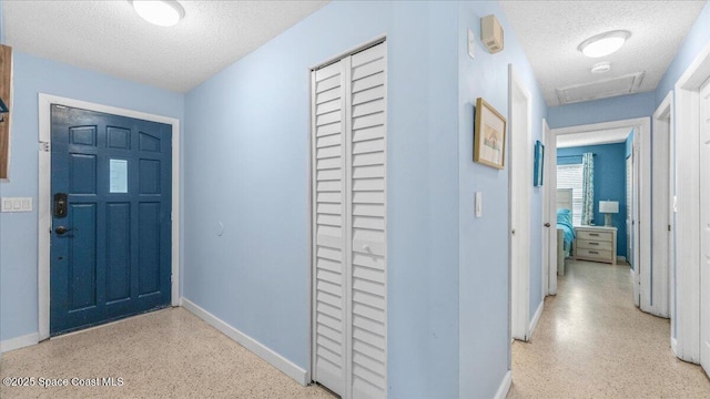 foyer entrance featuring a textured ceiling