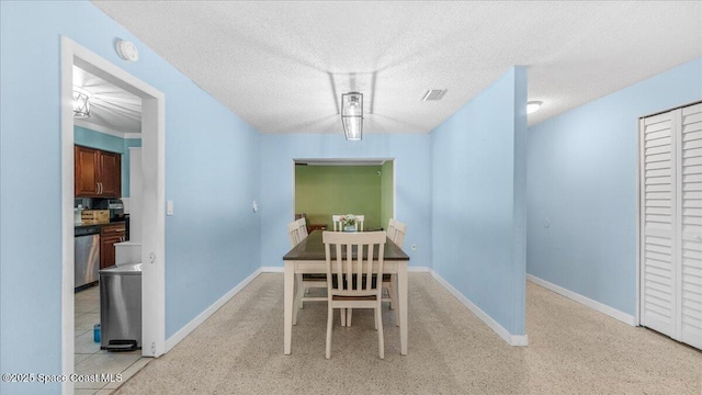 dining room featuring a textured ceiling