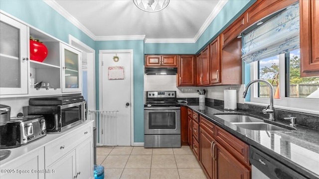 kitchen featuring ornamental molding, stainless steel appliances, sink, light tile patterned floors, and dark stone countertops