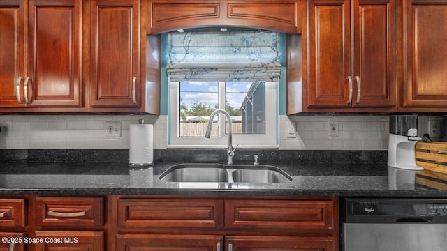 kitchen featuring dark stone counters, backsplash, sink, and stainless steel dishwasher