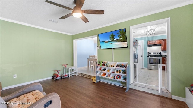 bedroom with a textured ceiling, ceiling fan, dark hardwood / wood-style floors, and crown molding