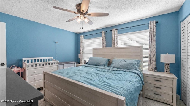 bedroom with a textured ceiling and ceiling fan