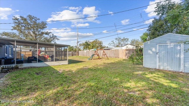 view of yard with a sunroom and a playground