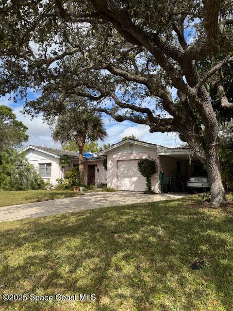 ranch-style home featuring a front yard and a garage