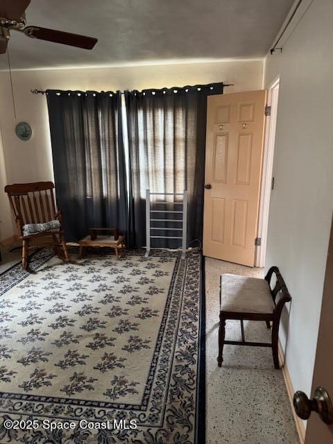 sitting room featuring ceiling fan