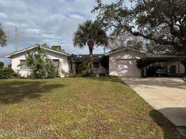 ranch-style home featuring a carport, a garage, and a front yard