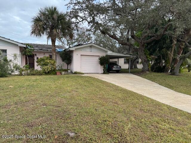 single story home with a front yard, a garage, and a carport