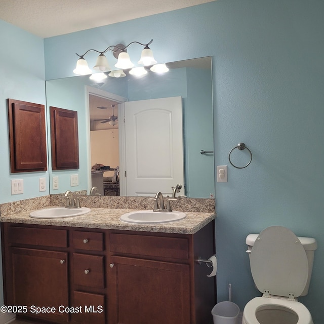 bathroom featuring ceiling fan, toilet, and vanity