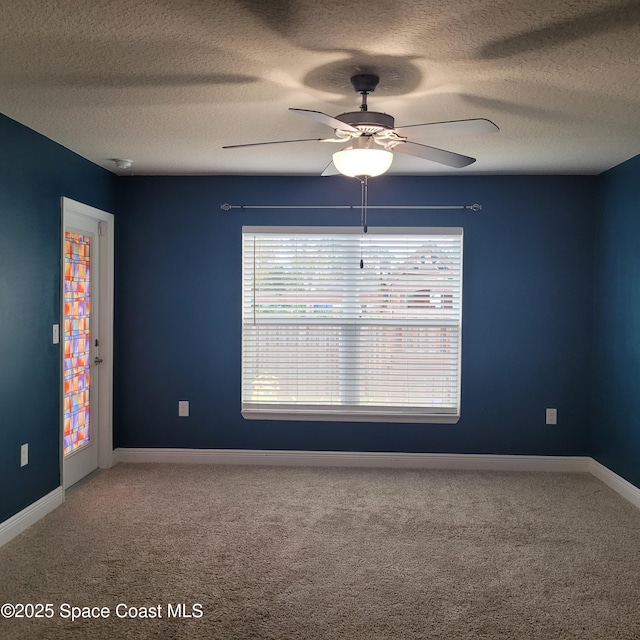 empty room featuring carpet flooring, a textured ceiling, and ceiling fan