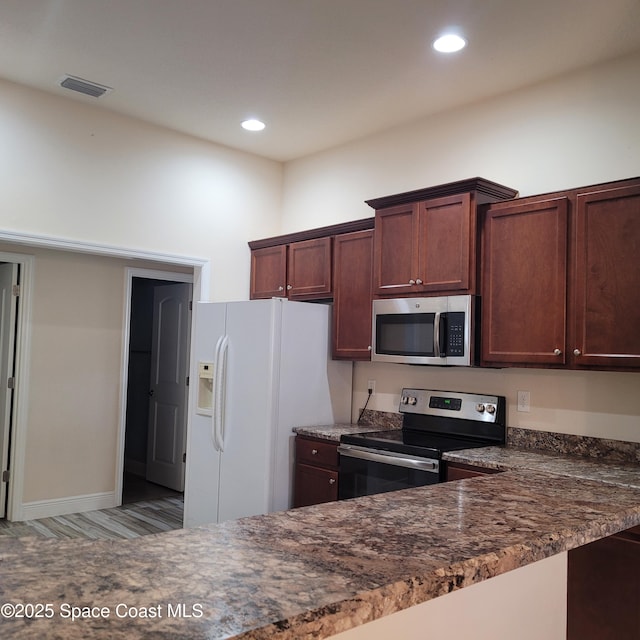 kitchen featuring dark stone countertops and stainless steel appliances