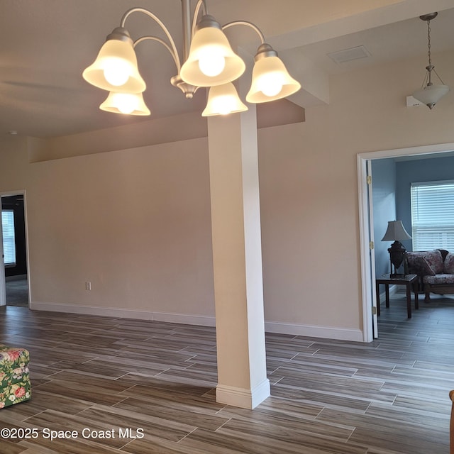 unfurnished room featuring a notable chandelier